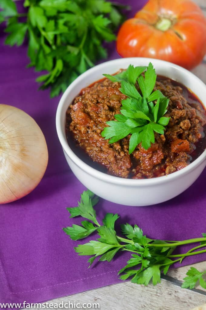 Paleo and Whole30 Chili in a white bowl on a purple cloth