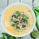 Creamy and spicy with hints of lime, this easy + healthy Paleo and Whole30 Coconut Curry Chicken Soup is the perfect slow cooker meal.
