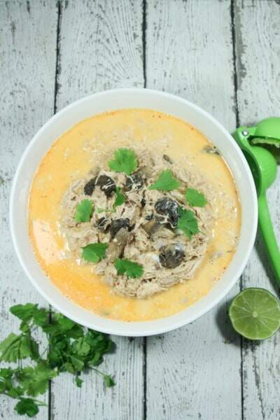 Creamy and spicy with hints of lime, this easy + healthy Paleo and Whole30 Coconut Curry Chicken Soup is the perfect slow cooker meal.