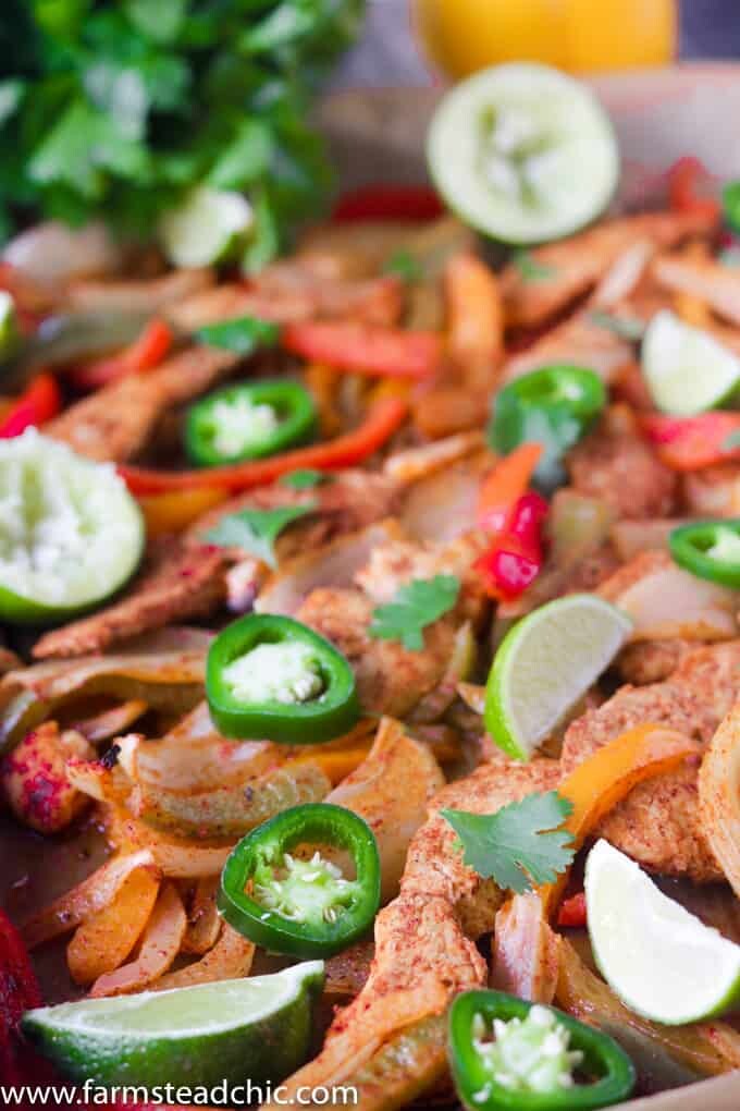 This Paleo and Whole30 Chicken Fajitas Sheet Pan Dinner is simple and easy with minimal cleanup! Serve it with some lime wedges, cilantro and guacamole.