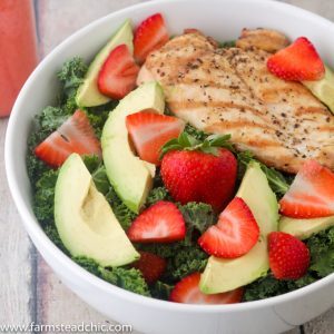 This Paleo and Whole30 Strawberry Avocado Kale Salad has a base of kale. Add grilled chicken to make it a full meal and drizzle with Strawberry Vinaigrette. A simple gluten free, grain free and dairy free superfood meal! Leave off the chicken for a vegetarian and vegan side salad.