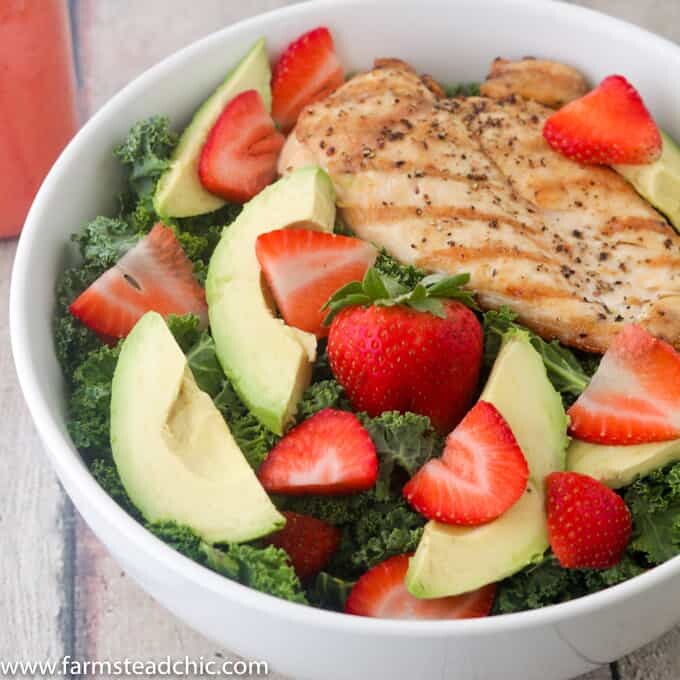 This Paleo and Whole30 Strawberry Avocado Kale Salad has a base of kale. Add grilled chicken to make it a full meal and drizzle with Strawberry Vinaigrette. A simple gluten free, grain free and dairy free superfood meal! Leave off the chicken for a vegetarian and vegan side salad.
