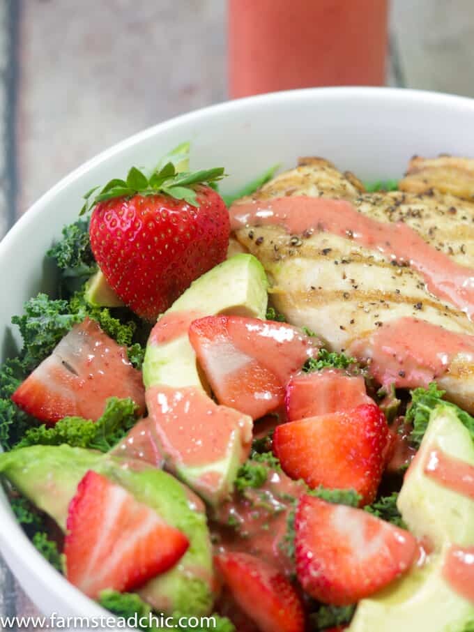 This Paleo and Whole30 Strawberry Avocado Kale Salad has a base of kale. Add grilled chicken to make it a full meal and drizzle with Strawberry Vinaigrette. A simple gluten free, grain free and dairy free superfood meal! Leave off the chicken for a vegetarian and vegan side salad.