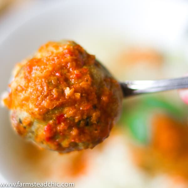 Low Carb, Keto Curry Turkey Meatballs served over cauliflower rice and topped with red curry sauce and fresh Thai basil