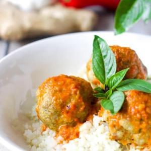 Low Carb, Keto Curry Turkey Meatballs served over cauliflower rice and topped with red curry sauce and fresh Thai basil