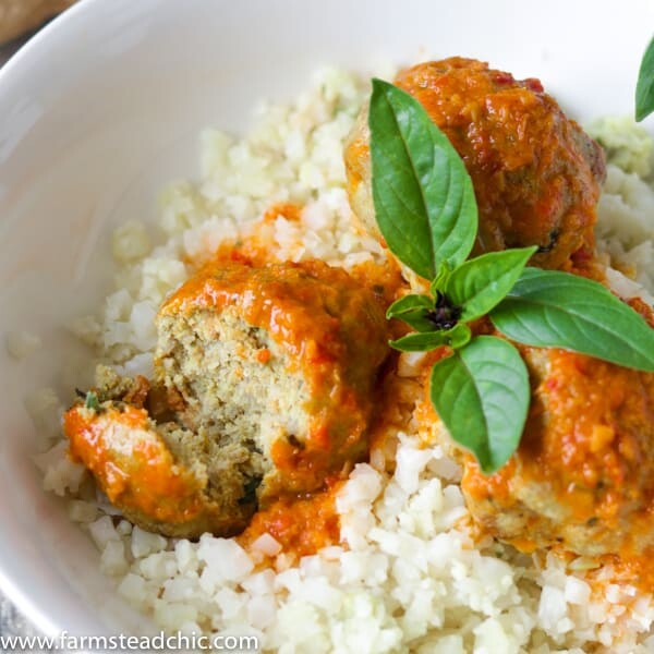 Low Carb, Keto Curry Turkey Meatballs served over cauliflower rice and topped with red curry sauce and fresh Thai basil