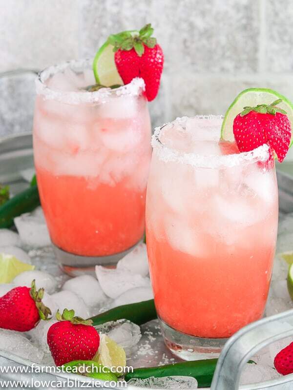 These Low Carb, Keto Strawberry Serrano Margaritas are the perfect complement to your Keto Summer BBQ. Made with a fresh strawberry, a serrano pepper and fresh lime juice, these Keto margaritas are fresh, sweet, spicy and tangy. And they only have 3 net carbs each! #farmsteadchic #ketomargarita #lowcarbmargarita #ketococktail #lowcarbcocktail #margaritarecipe #strawberrymargarita #spicymargarita