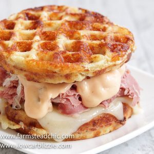 The perfect Chaffle bread, shaved corn beef, juicy sauerkraut, crunchy dill pickles, melty Swiss cheese and Thousand Island dressing make this Keto Reuben Chaffle taste better than the real thing without all the harmful additives and questionable ingredients. #ketoreuben #reubenchaffle #lowcarbreuben #lowcarbsandwich #chaffle #farmsteadchic