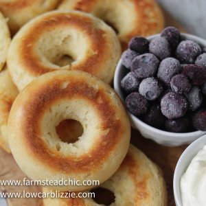 These Low Carb, Keto Bagels are based on the Fathead dough recipe and use mozzarella cheese, cream cheese, almond flour and eggs to make a dough that's surprisingly light and cream-cheese-spreadable. Add some smoked salmon, capers and sliced red onion for a Bagel and Lox. #farmsteadchic #lowcarbbagel #ketobagel #bagelandlox #smokedsalmonbagel #fatheadbagel #lowcarbbreakfast #ketobreakfast