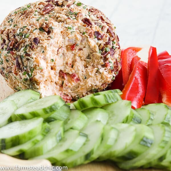 This Low Carb, Keto Pineapple Ham Cheese Ball is a guilt-free, flavorful appetizer for your holiday party. Freshly cooked country ham, toasted coconut, monk fruit, pineapple extract, roasted red peppers, chives, freshly shredded cheddar cheese and hot sauce all come together for a salty, sweet, spicy (low carb) spin on a traditional Hawaiian cheese ball. #farmsteadchic #cliftyfarm #ketocheeseball #lowcarbcheeseball #ketoappetizer #lowcarbappetizer