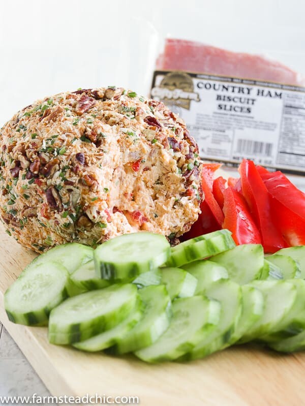 This Low Carb, Keto Pineapple Ham Cheese Ball is a guilt-free, flavorful appetizer for your holiday party. Freshly cooked country ham, toasted coconut, monk fruit, pineapple extract, roasted red peppers, chives, freshly shredded cheddar cheese and hot sauce all come together for a salty, sweet, spicy (low carb) spin on a traditional Hawaiian cheese ball. #farmsteadchic #cliftyfarm #ketocheeseball #lowcarbcheeseball #ketoappetizer #lowcarbappetizer