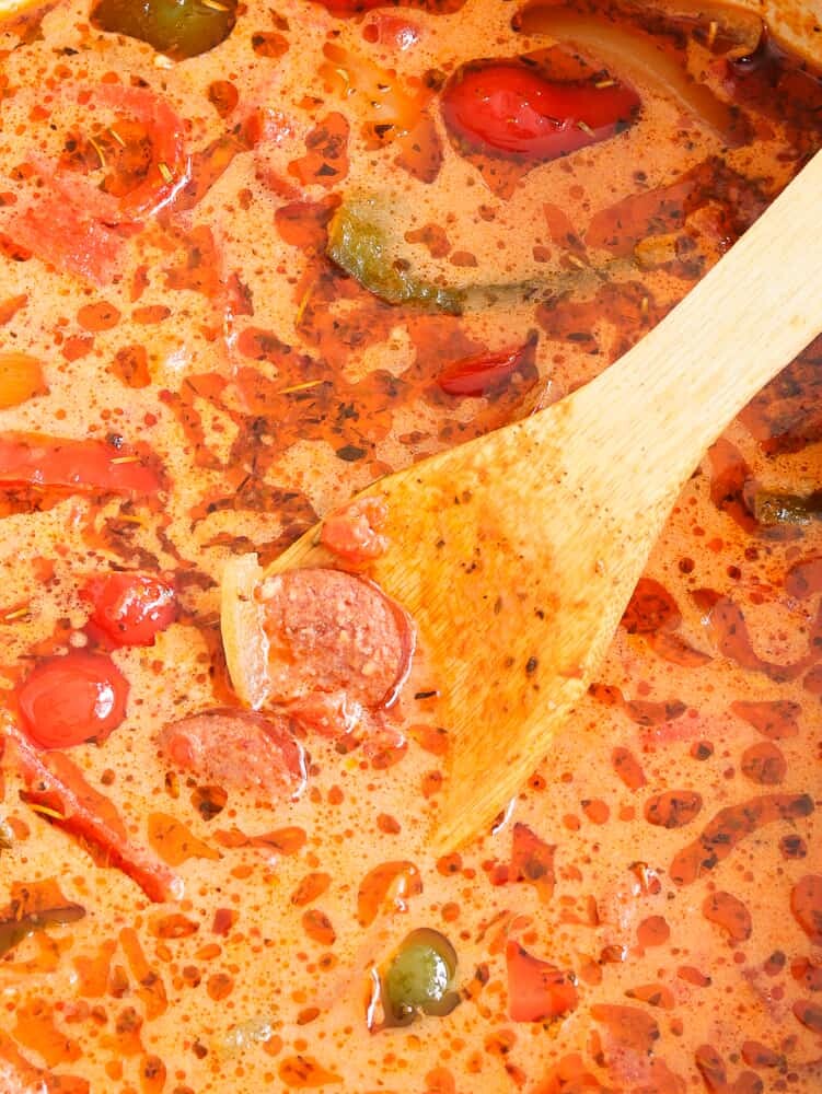 This Low Carb, Keto Sausage and Peppers Soup is full of so many fresh flavors! Crispy-browned beef kielbasa, sweet red and green bell peppers and savory onions simmer in a chicken and tomato-based broth. Freshly minced garlic and Italian seasoning provide plenty of favor, and heavy cream balances out the spiciness of crushed red pepper. #farmsteadchic #lowcarbsoup #ketosoup #sausageandpeppers #creamysoup #kielbasa #sausagesoup
