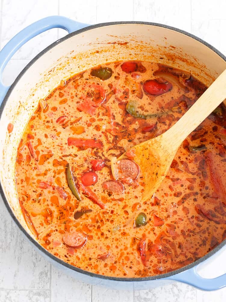 This Low Carb, Keto Sausage and Peppers Soup is full of so many fresh flavors! Crispy-browned beef kielbasa, sweet red and green bell peppers and savory onions simmer in a chicken and tomato-based broth. Freshly minced garlic and Italian seasoning provide plenty of favor, and heavy cream balances out the spiciness of crushed red pepper. #farmsteadchic #lowcarbsoup #ketosoup #sausageandpeppers #creamysoup #kielbasa #sausagesoup